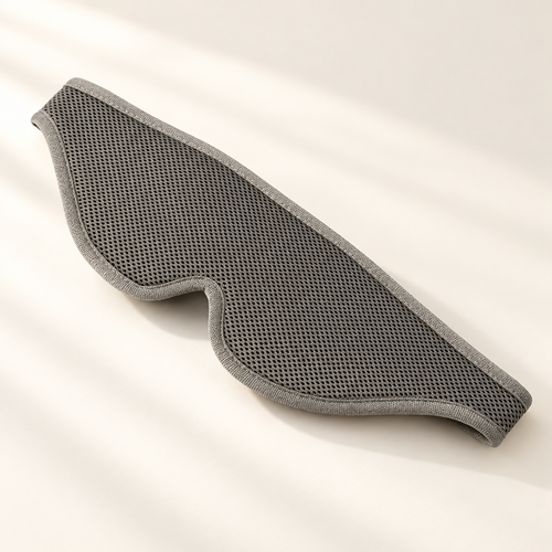 Adjustable 3D Blackout Sleep Mask on a warm ivory studio background
