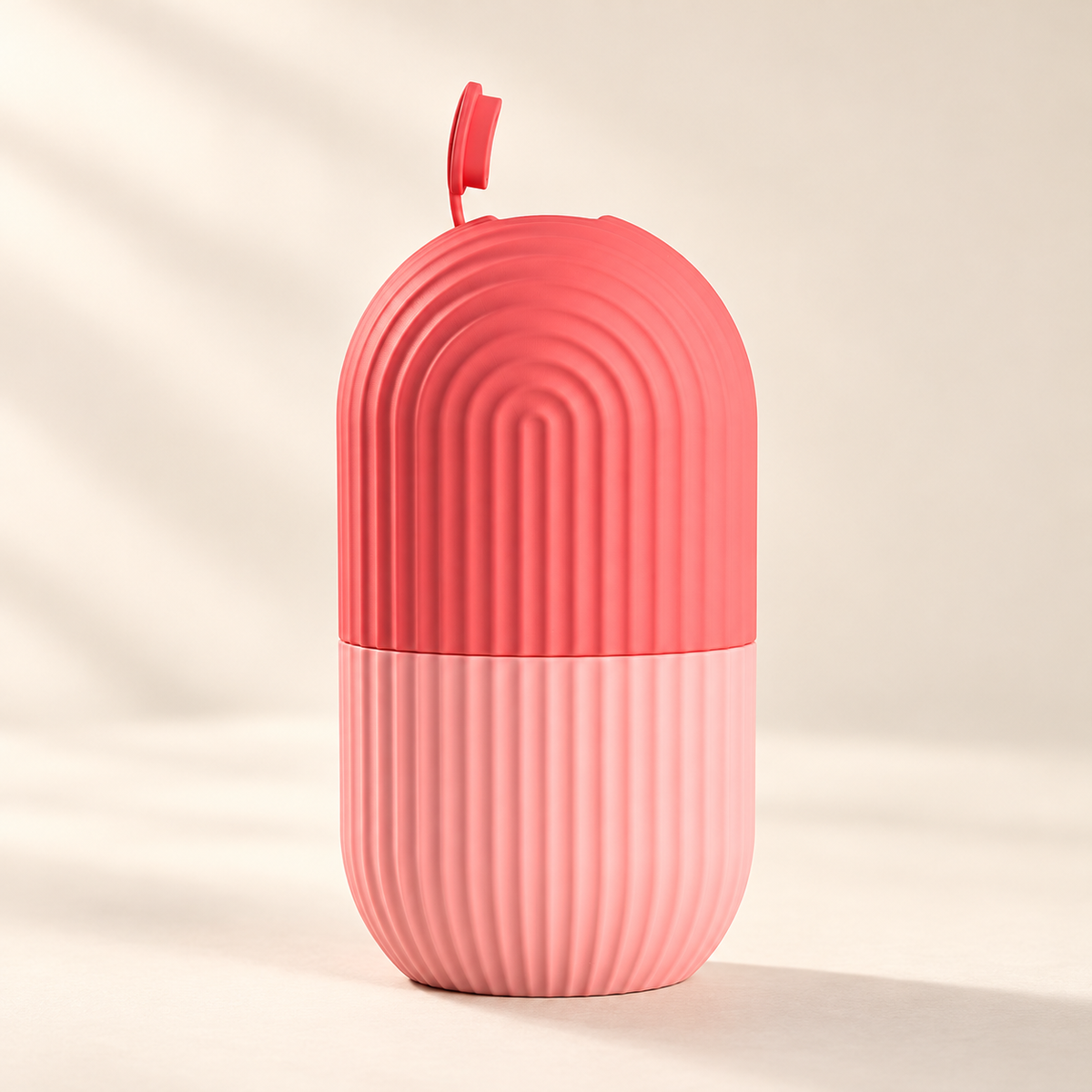 Reusable Facial Ice Roller Mold on a warm ivory studio background