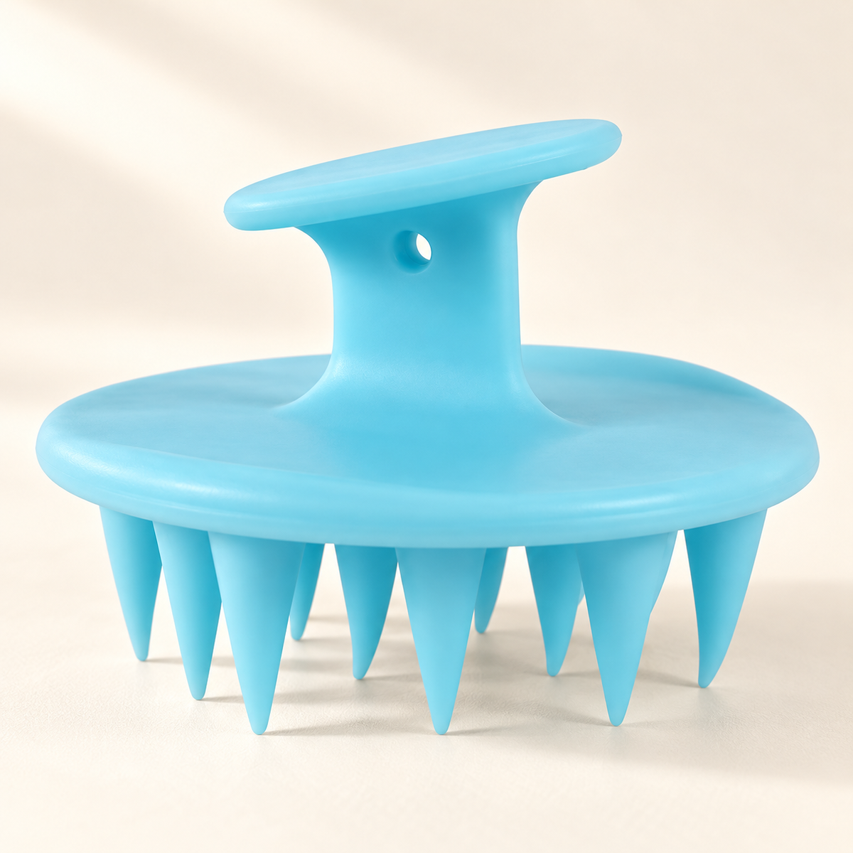 Silicone Shampoo Brush & Scalp Massager on a warm ivory studio background