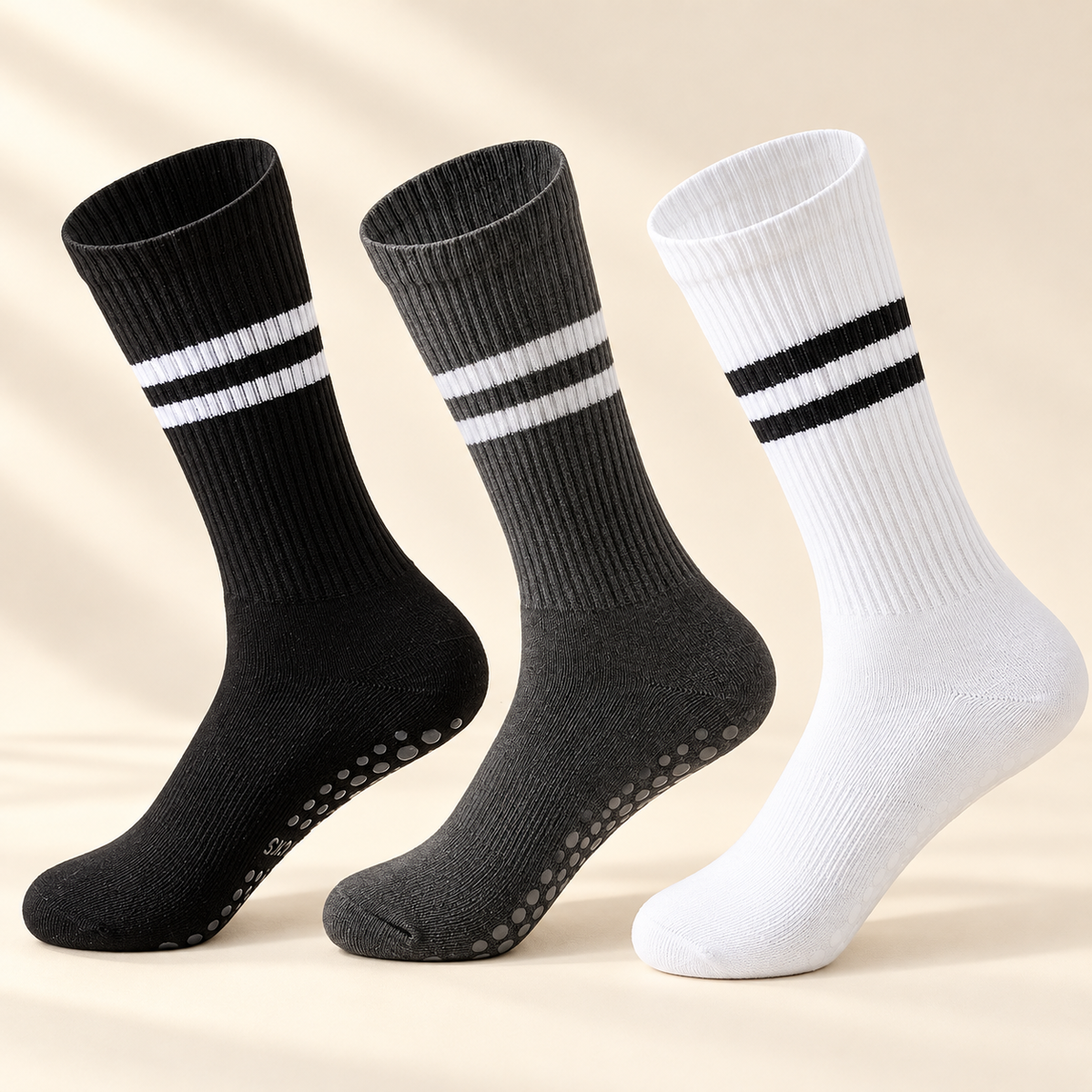 Pilates Grip Socks, 3-Pair Pack — Black, White & Grey on a warm ivory studio background